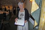 A delighted Pat Johns proudly displaying her Paul Harris Award from DG Paul Edwards.